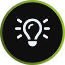 A simple white light bulb icon with rays on a black circular background, bordered by a green ring, symbolizing an idea or inspiration.