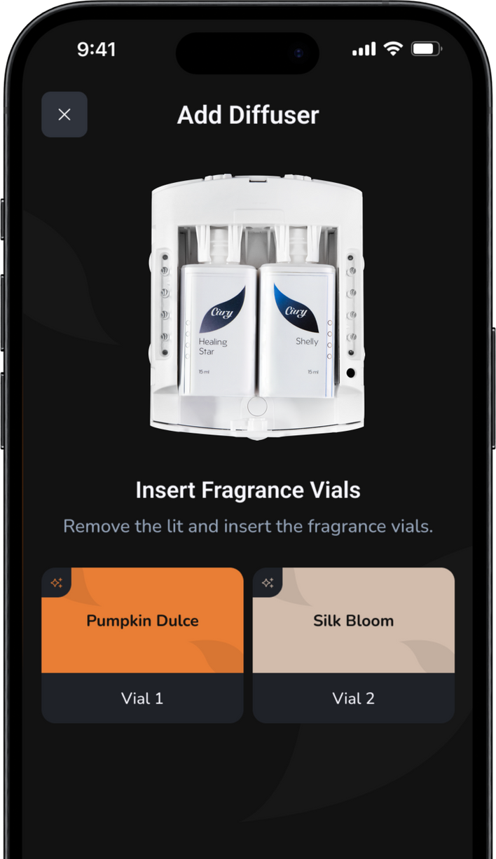 A smartphone screen shows an app with instructions to add a diffuser. Two fragrance vials, labeled “Healing Star” and “Shelby,” are loaded in the diffuser. Fragrance options “Pumpkin Dulce” and “Silk Bloom” are listed below.